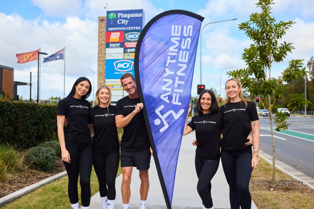 Pimpama presale team with an Anytime Fitness flag
