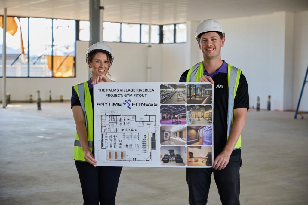 Riverlea team in hard hats with the fit-out plan