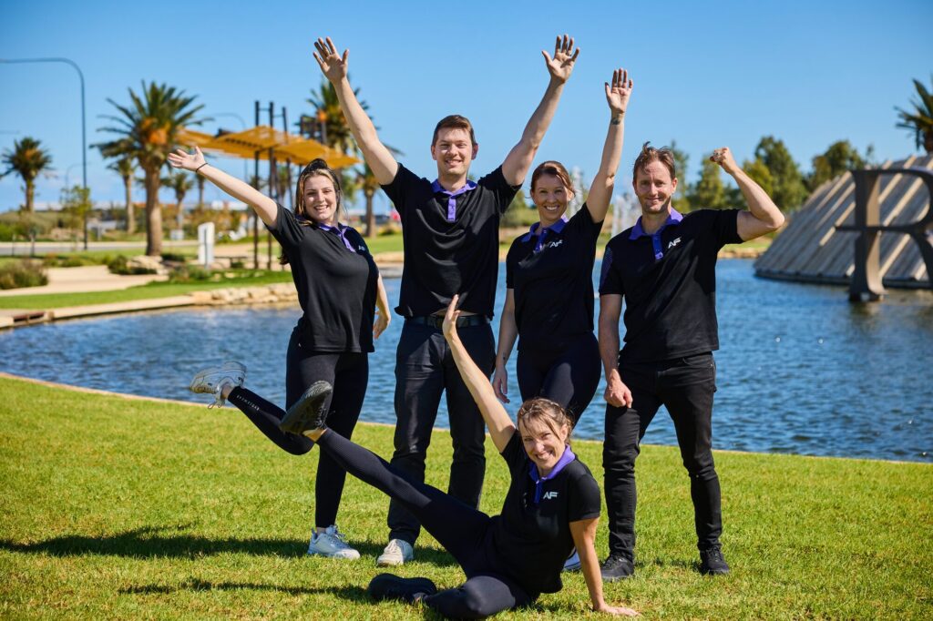 Riverlea team celebrating by the lake
