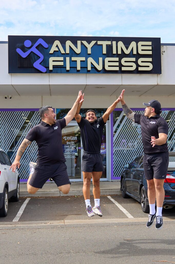 Watergardens team jumping outside the club